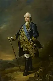 Portrait en pied, en costume bleu aux broderies dorées, canne à la main dans un paysage
