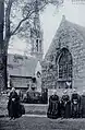 Vieilles femmes devant l'église Saint-Nicaise au début du XXe&nbsp;siècle (carte postale Villard).