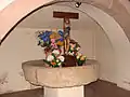 Ancienne meule du moulin de l’abbaye dans la crypte.