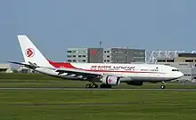 Un Airbus A330-300 d'Air Algérie, vol AH2701, avant le décollage, sur le taxiway A, avec le centre d'Air Canada en arrière-plan.