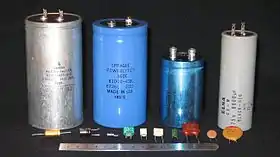 Des condensateurs de diverses capacités (au deuxième plan, 5 000 µF, 81 000 µF, 6 500 µF et 8 000 µF, devant des condensateurs de moindre capacité).