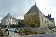 Vue en couleur d'un corps de bâtiment au toit d'ardoises, suivi d'un second corps parallèle en arrière plan.