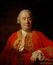 portrait d'homme assis, regardant de face, richement vêtu, portant une veste rouge.