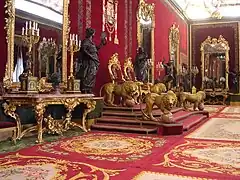Salle du Trône aux murs recouverts de velours de Gênes cramoisi et au trône symbolique protégé par 4 lions dorés.