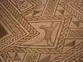 Photographie d'un détail de mosaïque polychrome représentant un tigre.