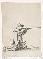 Soldat à genoux visant au fusil.