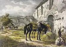 Chevaux sellés mangeant leur foin devant une bâtisse en pierre.