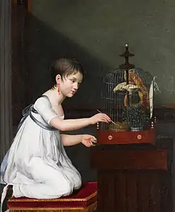 Une jeune fille nourrissant ses oiseaux dans une cage, non daté, localisation inconnue.