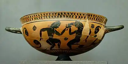 Coupe comaste attique à figures noires, vers -560.