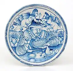 Plat peint d'un "Mangeur de macaronis", majolique de Laterza, dernier quart du XVIIe&nbsp;siècle.