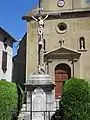 Statue du Christ en croix devant l'église.