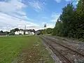 L'ancienne gare.Un TER se dirigeant vers Morteau en approche.