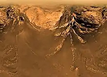 Image de montagnes de couleur rouille avec des formations blanches près de sommets similaires à de la neige.