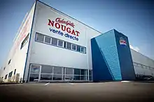 L'aspect d'architecture industrielle est donné par le bardage, très présent depuis la décennie 1960. Le bardage translucide en fibre de verre disponible au milieu du XXe&nbsp;siècle permet une nouvelle formulation de la couverture appuyée sur des portiques qui libèrent l'espace. Usine construite en 2009.