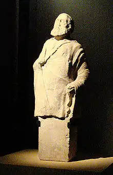 Portrait de Straton, citoyen d'Aï Khanoum, sur un pilier hermaïque dédié aux divinités du gymnase, calcaire, h : 77&nbsp;cm, musée national d'Afghanistan.