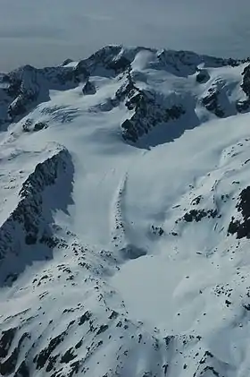 En contrebas du sommet, le glacier et le lac des Quirlies recouverts de neige.