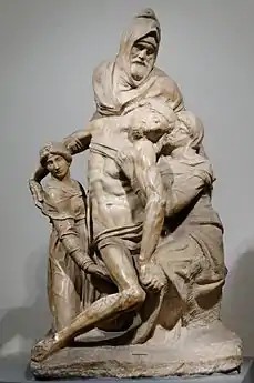 Sculpture en marbre inachevée, montrant le Christ mort soutenu par trois personnages.
