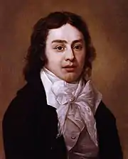 Buste, homme en jaquette, chemise blanche, nœud de ruban blanc, cheveux ondulés mi-courts.