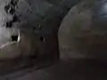 Pièce intérieure. Mur enduit en opus signinum et trous de charpente