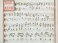 partition manuscrite rehaussée de couleurs rouge et verte en bordures et cadre de titre, titre en rouge