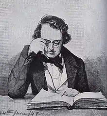Homme qui ajuste ses lunettes pour lire un livre posé sur une table, il est vêtu d'une veste. Une mention « 24th june 49 » figure écrite en bas à gauche.