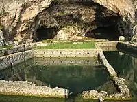 Grotte aménagée à l'arrière-plan, bassin-vivier et triclinium.
