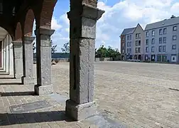 La place de la ville-haute avec la galerie au pied du beffroi qui date de la 1er moitié du XIXe&nbsp;siècle et reconstruite dans les années 1980.