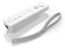 Manette de jeu vidéo, boite blanche équipée de boutons.